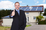 Businessman With Thumbs Up In Front Of House