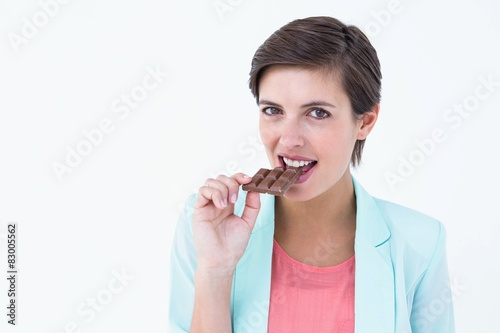 Pretty woman eating bar of chocolate 