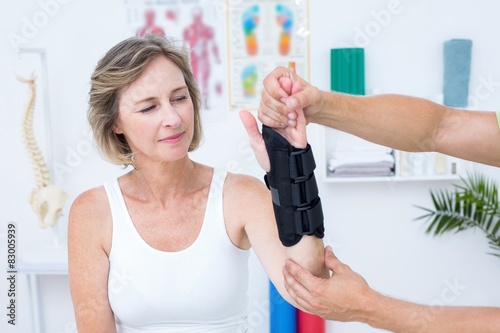 Doctor examining his patients wrist photo