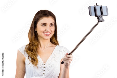Pretty woman using a selfie stick