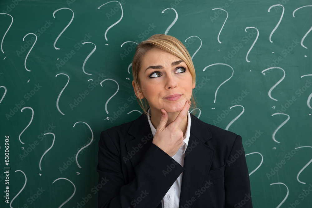 Contemplated Businesswoman In Front Of Chalkboard Contemplated Businesswoman In Front Of Chalkboard