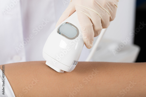 Close-up Of Beautician Giving Epilation Laser Treatment