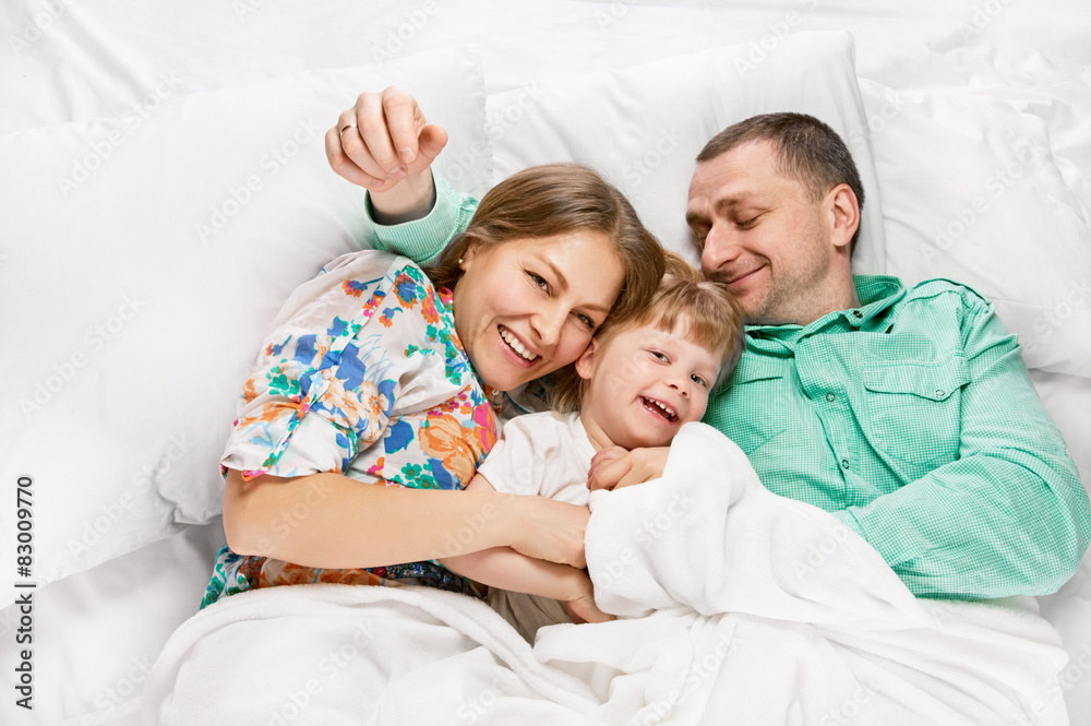 Fototapeta premium Happy mother and the father with cute daughter