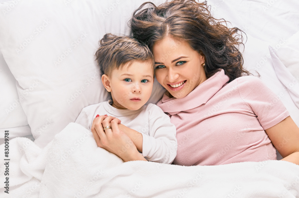 Mother playing with son on the bed Mother playing with son on the bed