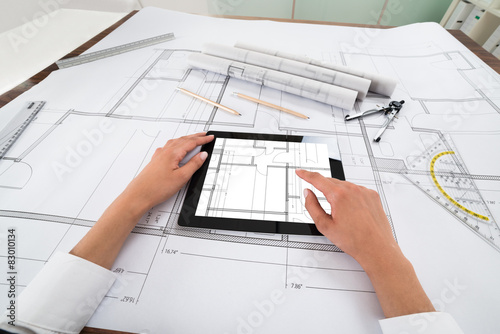 Architect With Digital Tablet Over Blueprint