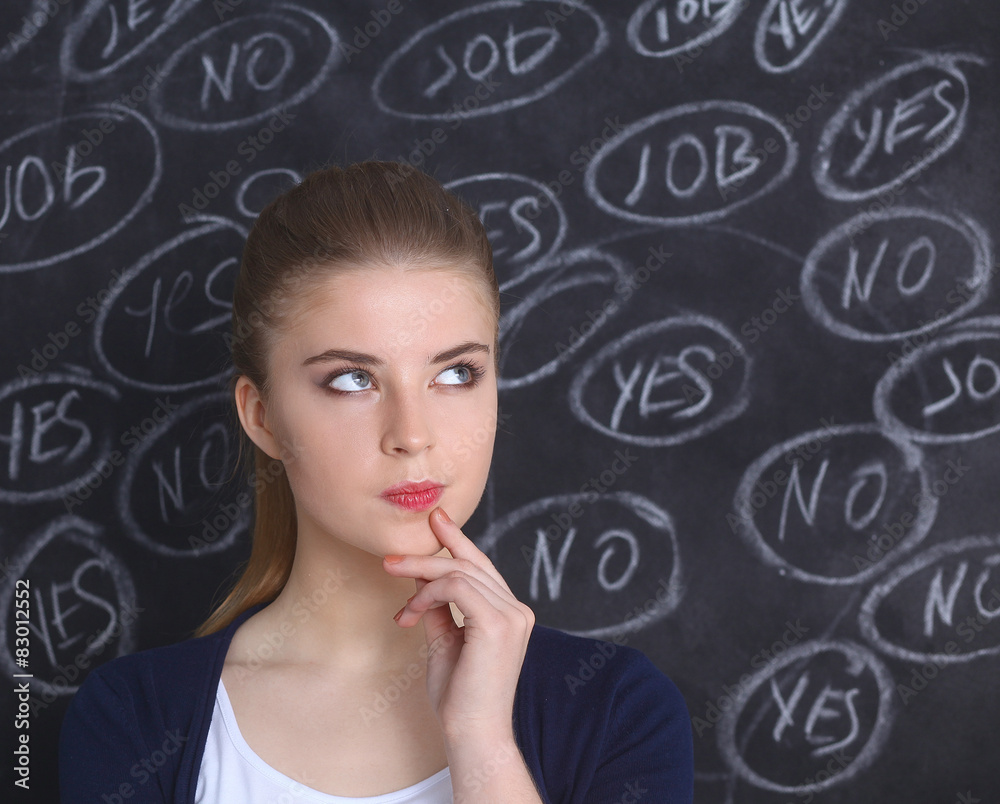 Thinking young woman with yes or no choice on grey background Thinking young woman with yes or no choice on grey background