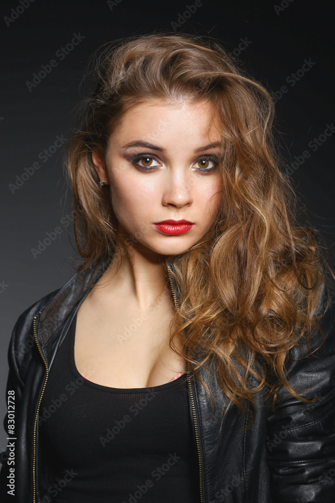 Portrait of beautiful young woman face. Isolated on dark Portrait of beautiful young woman face. Isolated on dark