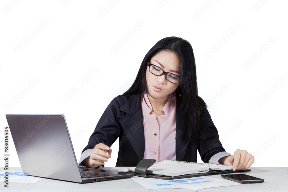 Young entrepreneur writes a plan on notebook Young entrepreneur writes a plan on notebook