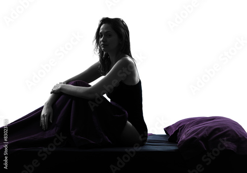  woman sad sitting on bed silhouette