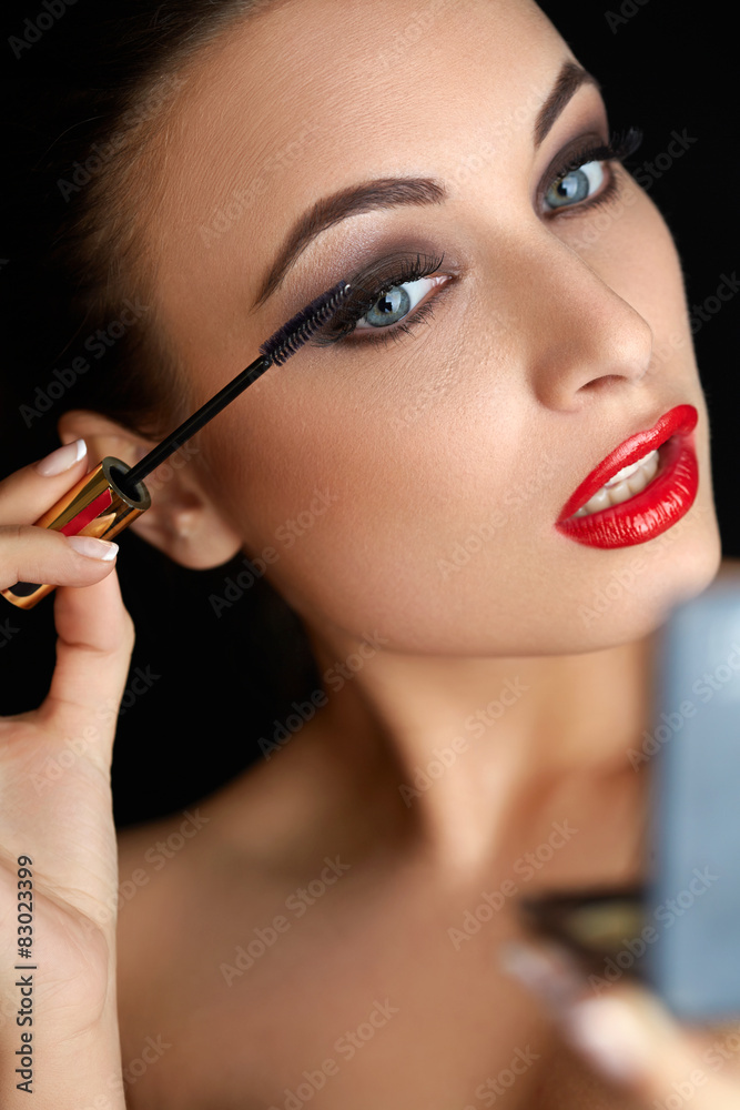 Make-up. Beautiful Woman Doing Makeup. Mascara Brush. Red Lips