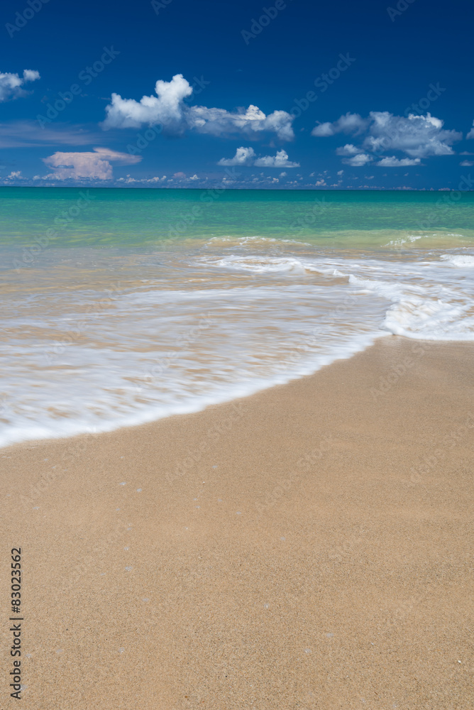 sea waves lash line impact on the sand beach under blue sky sea waves lash line impact on the sand beach under blue sky