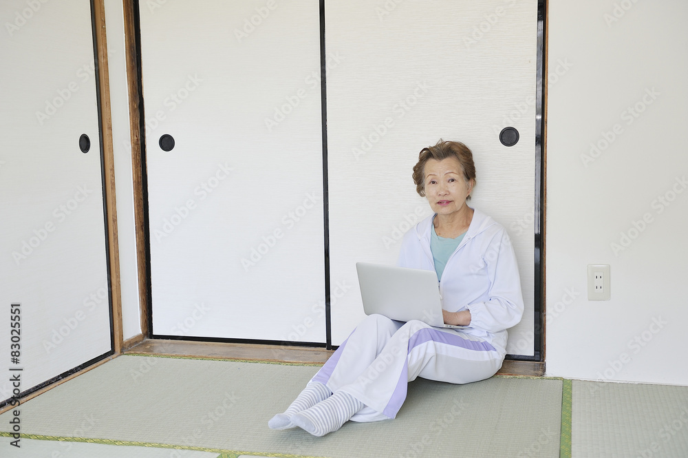 Female senior sportswear using a laptop Female senior sportswear using a laptop