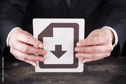 Man holding download icon in hands