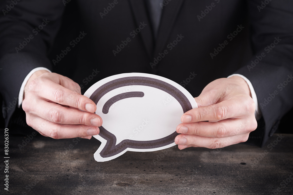 Man holding chat icon in hands