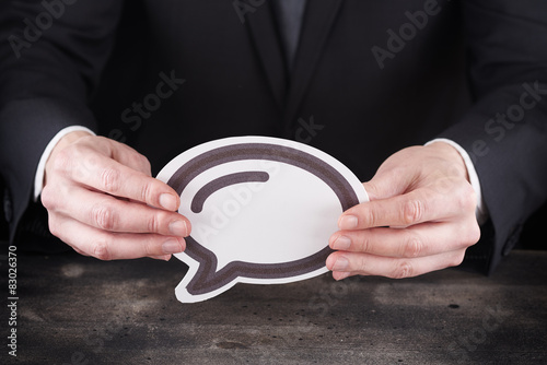 Obraz na płótnie Man holding chat icon in hands w salonie