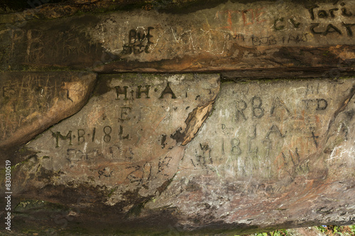 Carved graffiti. St Cuthbert's Cave. Northumbrland. England. UK. photo