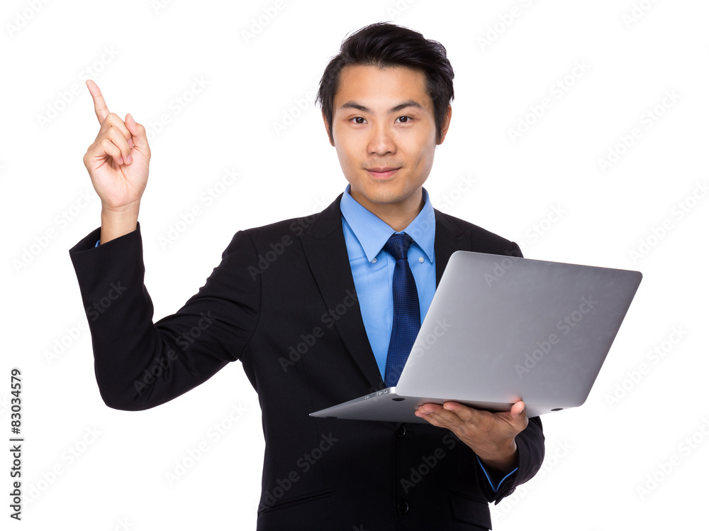 Young businessman hold with laptop computer and finger pointing Young businessman hold with laptop computer and finger pointing