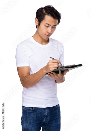 Asian man write on clipboard