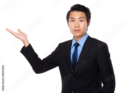 Young businessman with hand show with blank space