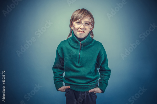European-looking boy of ten years in glasses hands in  pockets o © maxximmm