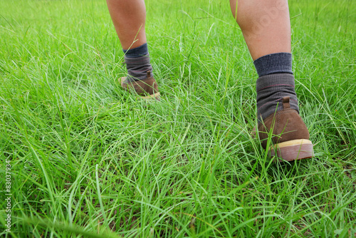 Hiking shoes on grass © leungchopan