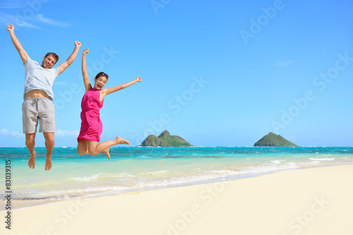 Happy fun tourists couple jumping Beach vacation