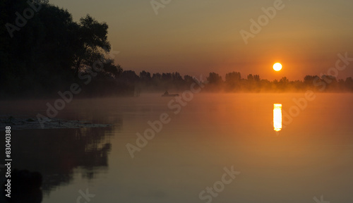 Fisherman on the sunrise, sunrise on the lake © ugreen