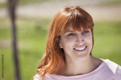 Portrait Of A Mature Red woman smiling and looking away © annawin