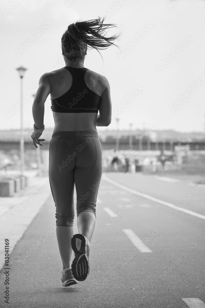 Woman running in the running track during a workout.