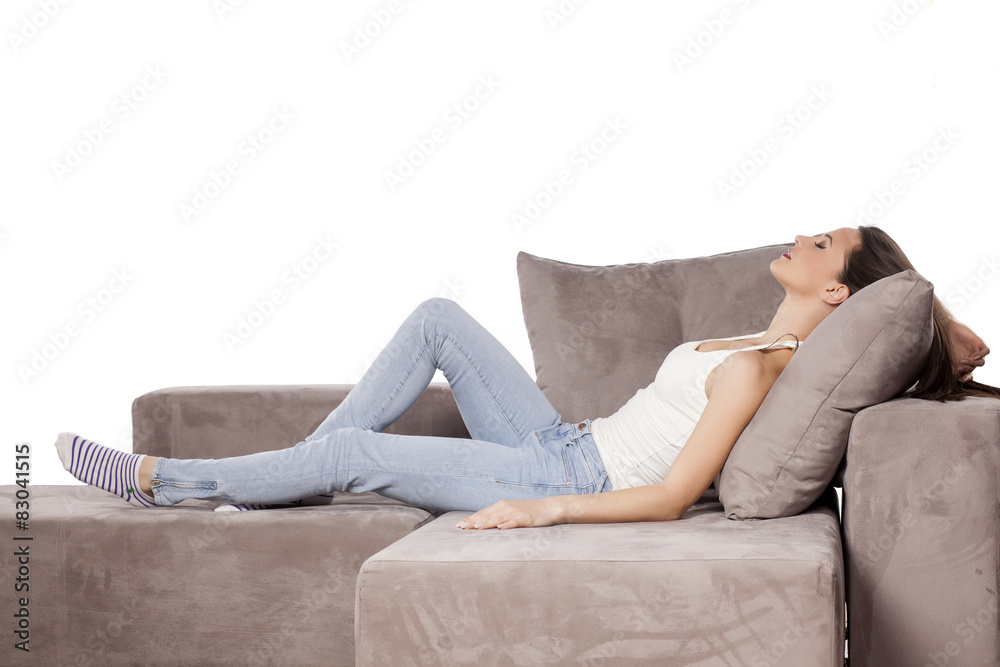 Fototapeta premium a beautiful young woman lying on the couch and sleeping