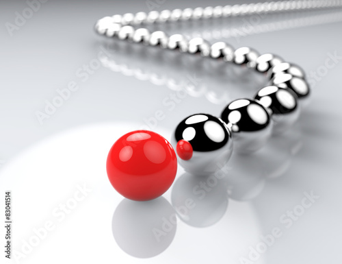 Red ball ahead of metal balls