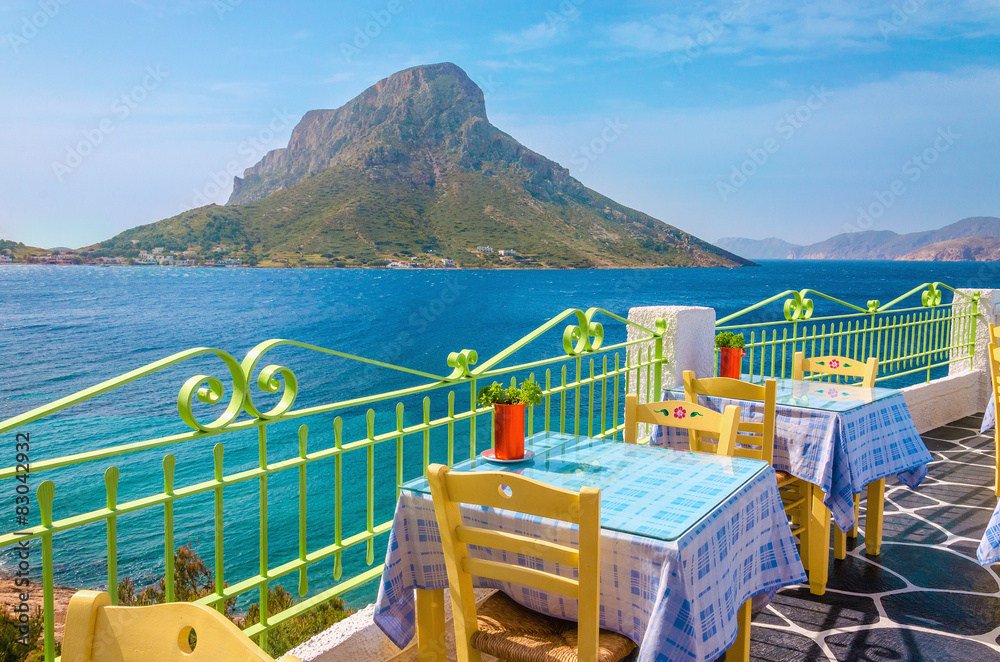 Colorful traditional Greek restaurant with view on sea and remot Colorful traditional Greek restaurant with view on sea and remot