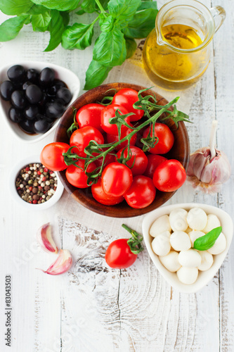 Tomatoes and mozzarella with basil leaves