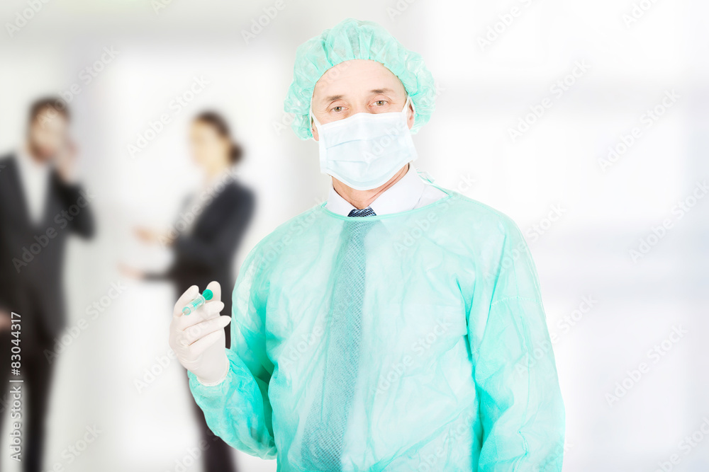 Surgeon doctor holding a syringe. Surgeon doctor holding a syringe.