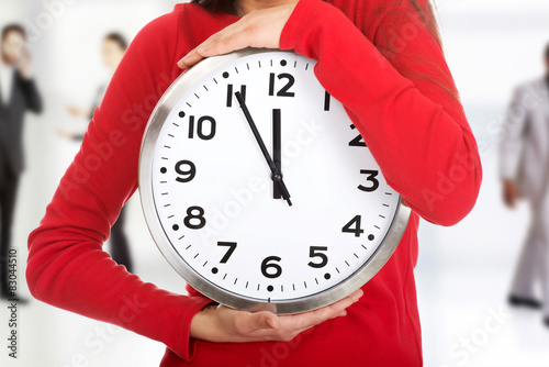 Young woman with a clock. photo