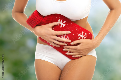 Canvas Print Woman with stomachache and hot water bottle.