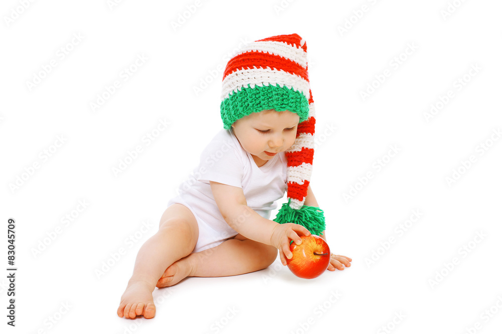 Christmas and childhood concept - little baby in bright knitted