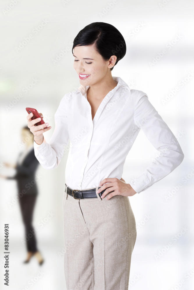 Business woman sending sms.