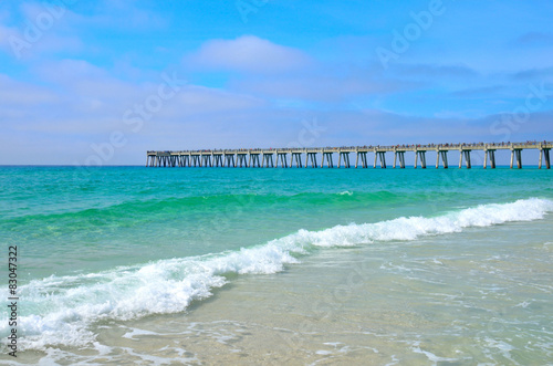 Pier stretching out over a Gulf of Mexico ocean beach