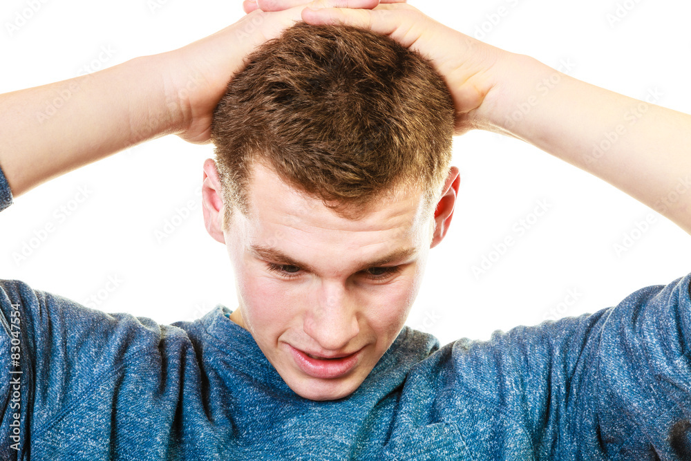 Fototapeta premium Closeup stressed man holds head with hands