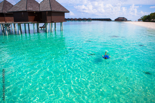 Young man snorkeling in clear tropical turquoise waters