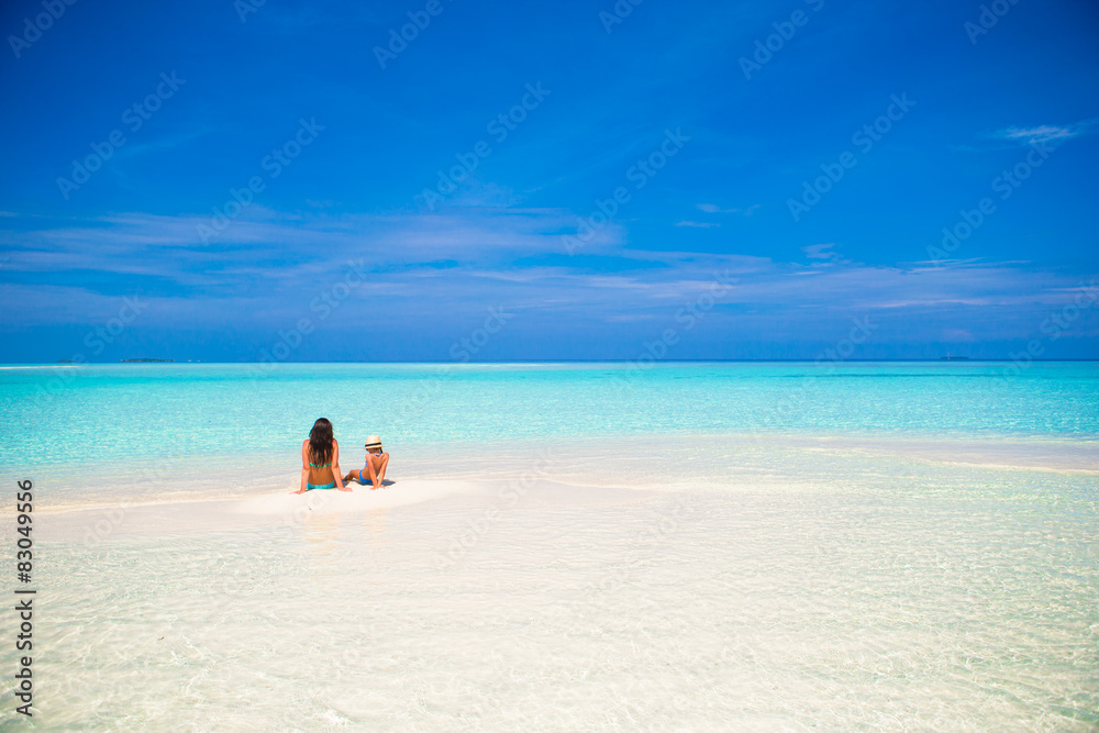 Little girl and young mother during beach vacation Little girl and young mother during beach vacation