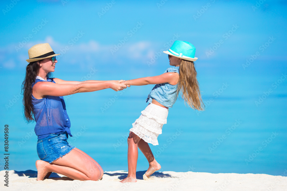 Mother and daughter enjoying time at tropical beach Mother and daughter enjoying time at tropical beach