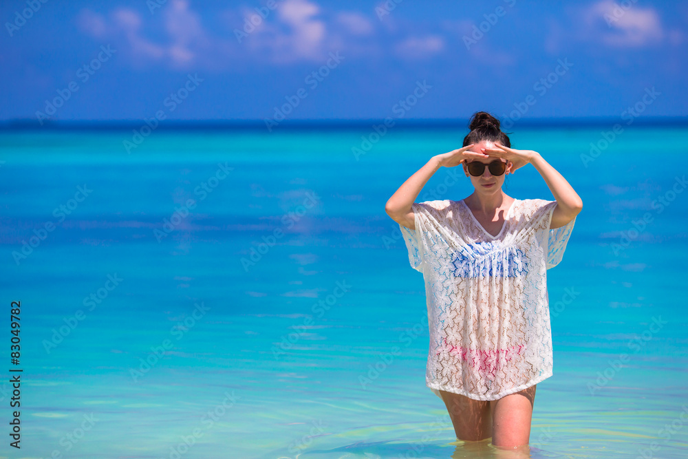 Young beautiful woman on beach during tropical vacation