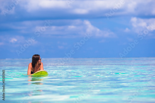 Beautiful surfer woman surfing during summer vacation