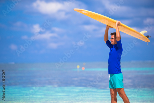 Happy young man surfing on the tropical coast © travnikovstudio