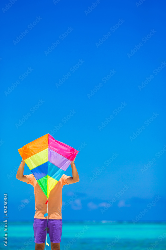 Young man with a kite on a background of turquoise sea