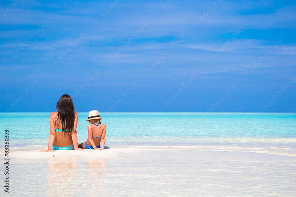 Little girl and young mother during beach vacation Little girl and young mother during beach vacation