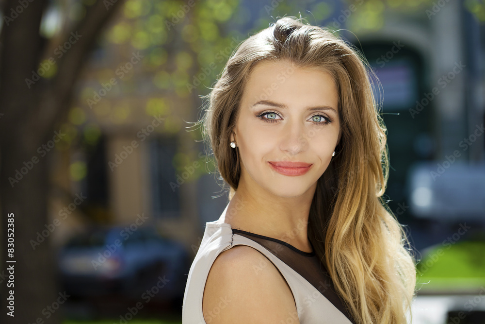 Portrait close up of young beautiful blonde woman, on background