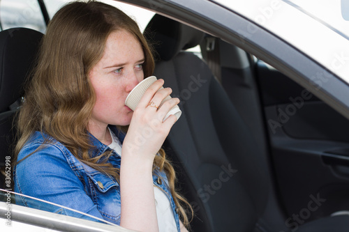 woman with coffee in the car © rm211171